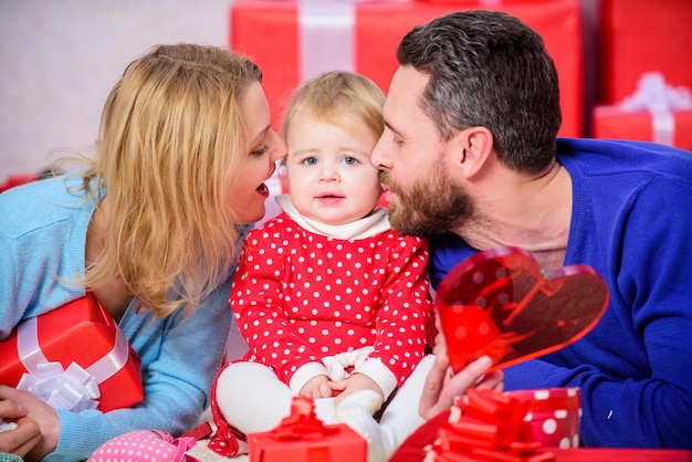 Celebrating love Boxing day Love and trust in family Bearded man and woman with little girl Happy family with present box father mother and doughter child Valentines day Red boxes