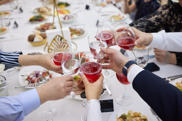 Celebrating with glasses of alcohol in hands Happy female friends having good time