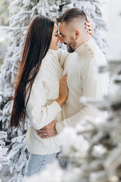 Celebration fun and holidays concept happy couple wearing ugly sweaters