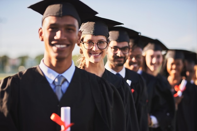 Celebration graduation and portrait of student woman outdoor on campus with friends for ceremony or event Certificate education and success with happy graduate people in line for award or future