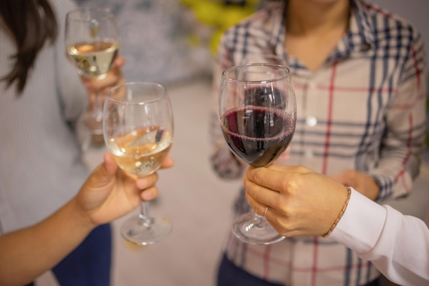 Celebration People holding glasses of white wine making a toast