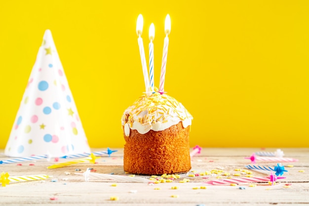 Celebratory cupcake with candles. Decorations for a birthday or holiday.