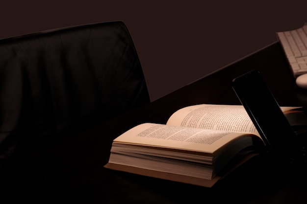 cell phone and power bank on the desk illuminates reading and study book with battery-powered comput