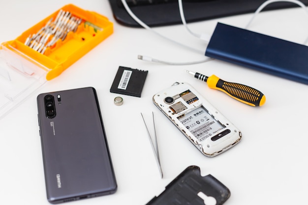 Cell phone repair. Smartphone parts and tools for recovery, selective focus