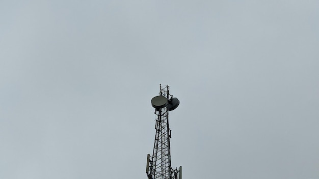 A cell tower with a cell phone tower on it