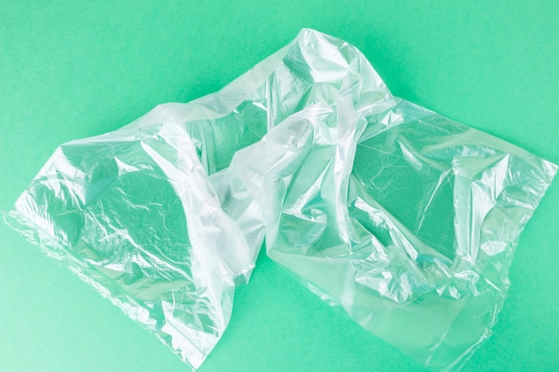 Cellophane transparent bag lies on a bright green background.