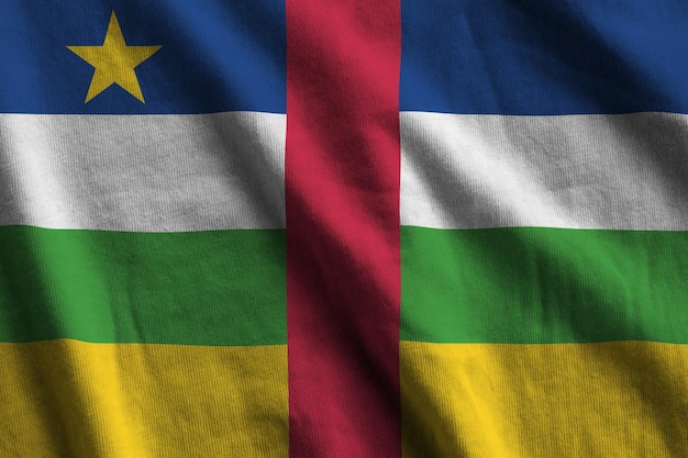 Central African Republic flag with big folds waving close up under the studio light indoors The official symbols and colors in banner