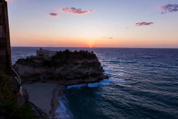 century monastery on top of the sanctuary of santa maria island during the sunset tropea