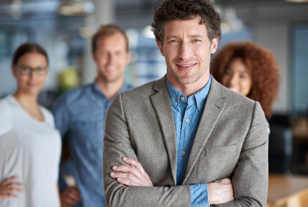 Photo ceo happy man and portrait in office with diversity for company collaboration and startup business executive director pride and leadership in workplace for project management in creative agency