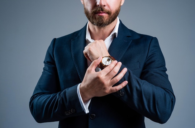 Ceo man in jacket with groomed beard hair show hand watch accessory