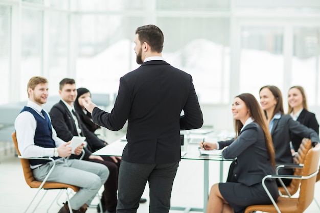 CEO speaks at the workshop business team in a modern office.