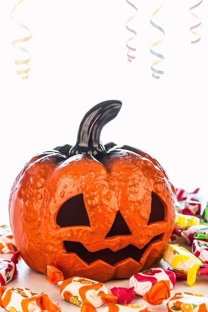 Ceramic pumpkin with many candies to celebrate halloween night