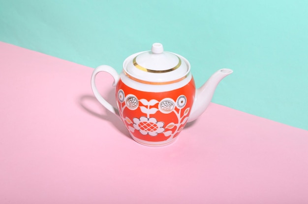 Ceramic retro teapot on bluepink background Minimalism Trendy shadow Creative layout