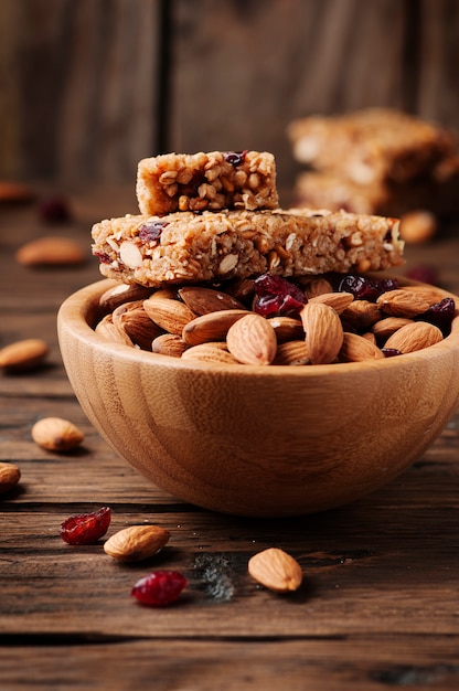 Cereal bar with almond and berry on thw wooden table