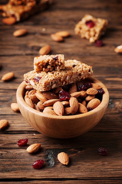 Cereal bar with almond and berry on thw wooden table