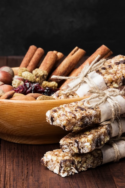 Cereal bars with different nuts and muesli and ingredients bowl