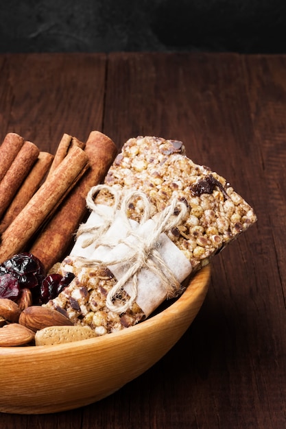 Cereal bars with different nuts and muesli and ingredients bowl