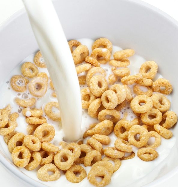 Cereal Bowl With Milk Pouring isolated on white