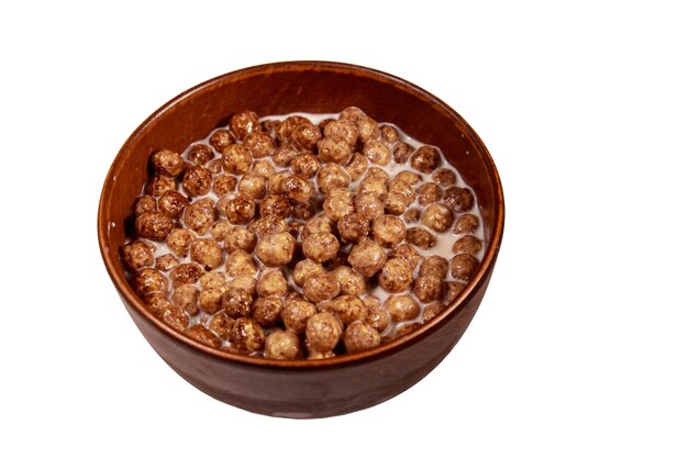 Cereal chocolate balls with milk in a bowl isolated on white background