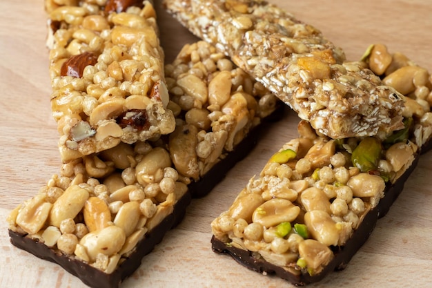 Cereal superfood energy bars with almond nuts dry fruits raisins chocolate on the wood table