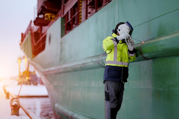 Certified Welder Technician Wearing The Protective Clothes And Equipment Working With A Welding Tool