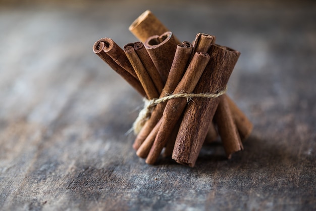 Ceylon cinnamon sticks on wooden background.