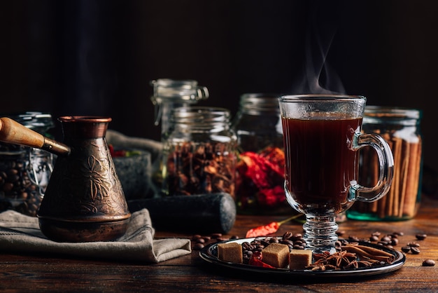 Cezve and Glass of Coffee with Beans Sugar Star Anise Cinnamon Stick and Chili Pepper on Tray