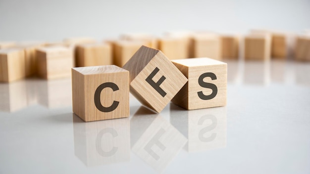 CFS word made from wooden cubes on gray background, cfs - short for Consolidated Financial Statement