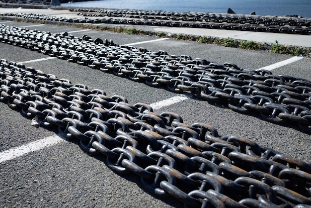 Chains for ships lies on the pier against the background of a cloudy sky and the Black Sea