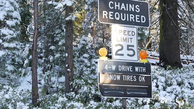 Chains or snow tires required road sign yosemite winter forest california usa