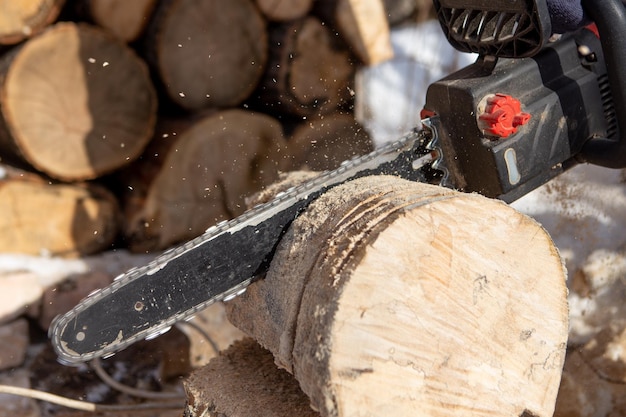 Chainsaw blade cutting log of wood Preparation firewood for the winter Natural living style