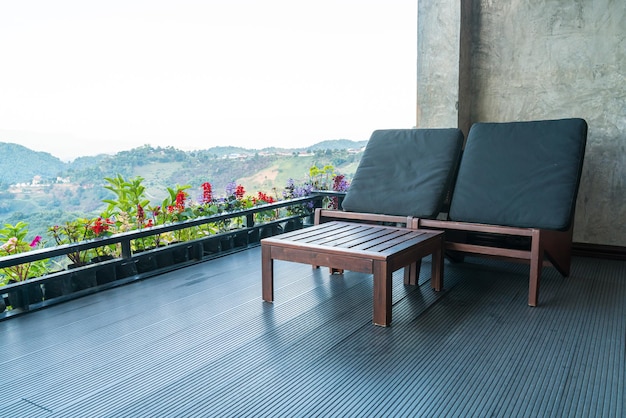 Chair on balcony with mountain hill background