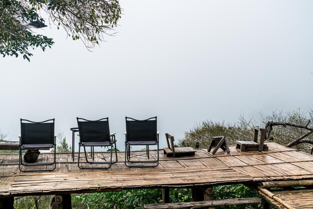 Chair on balcony with mountain hill and foggy background