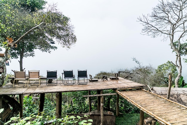 Chair on balcony with mountain hill and foggy background