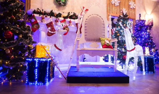 Chair for Santa Claus and boxes with gifts in a cozy living room. holiday concept