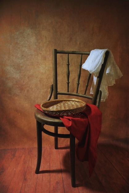 Photo a chair with a red blanket on it and a basket on the back