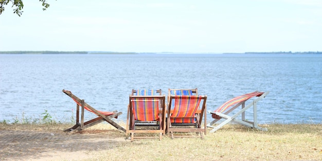 chairs and a lake in the background