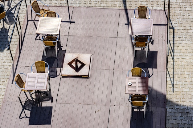 Chairs and tables in a cozy street cafe Top view