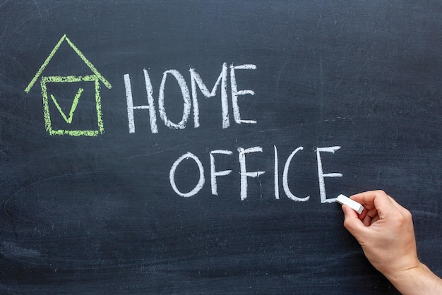 Chalk board with hand and inscription Home Office