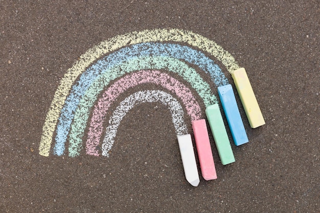 Chalk rainbow painted on the road The concept of hope for a happy future