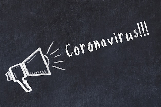 Chalk sketch of loudspeaker and warning inscription coronavirus