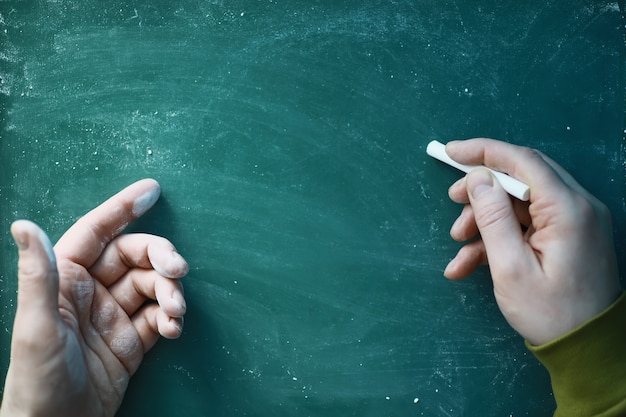 Chalkboard. Crayons for writing on a blackboard. Learning concept. School teaching chalk board.