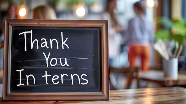 Photo chalkboard with text thank you interns in cozy cafe setting