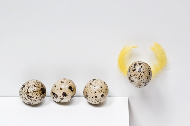 Challenge education ambition concept. Quail eggs on white