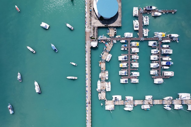 Chalong pier with sailboats and other boats at the seaBeautiful image for travel and tour website designAmazing phuket island view from drone seascape landscapeSummer day