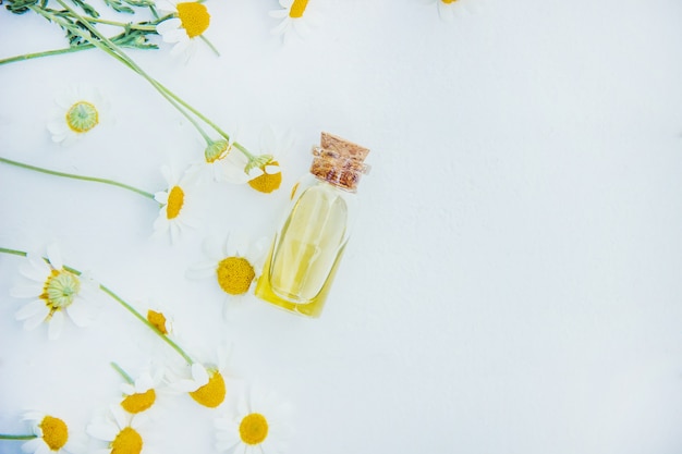 Chamomile extract in a small bottle. Selective focus.