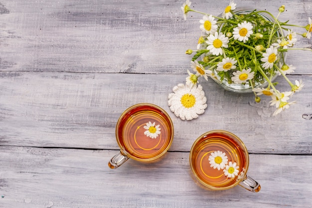 Chamomile tea. Fresh flowers, summer hot drink concept. Alternative medicine, lifestyle