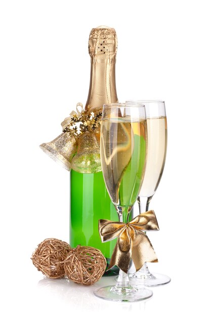 Champagne bottle, glasses and christmas decor. Isolated on white background