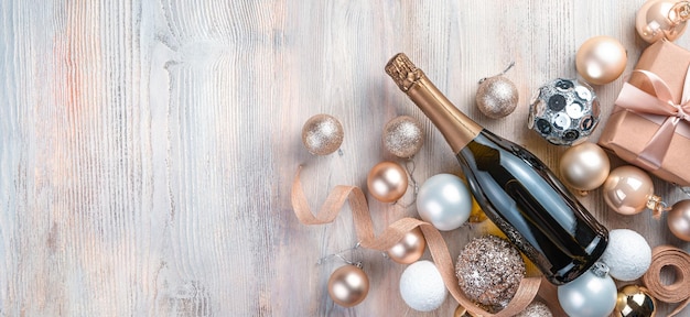 Champagne Christmas balls and gifts on a beige background