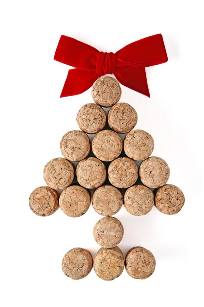 Champagne corks laid out in the shape of a Christmas tree tied up in red isolated on a white background